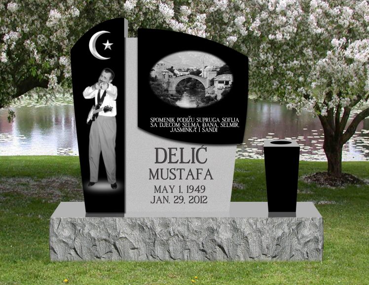 Black and grey granite monument with a crescent and star, an etched portrait and an etched stone bridge