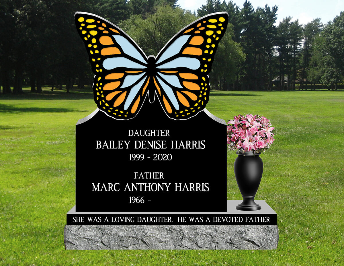 Black granite monument with a butterfly shaped top in orange, yellow and blue