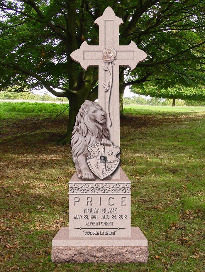 Rose granite cross monument with a carved lion holding a shield and a carved rose
