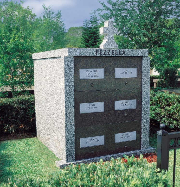 Six crypt granite family mausoleum with a carved cross on top