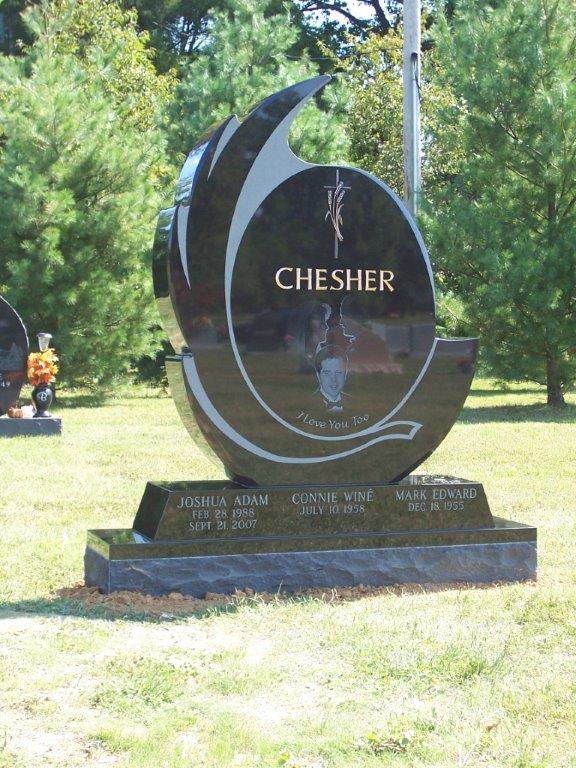 Black granite crescent shaped monument with a laser etched portrait
