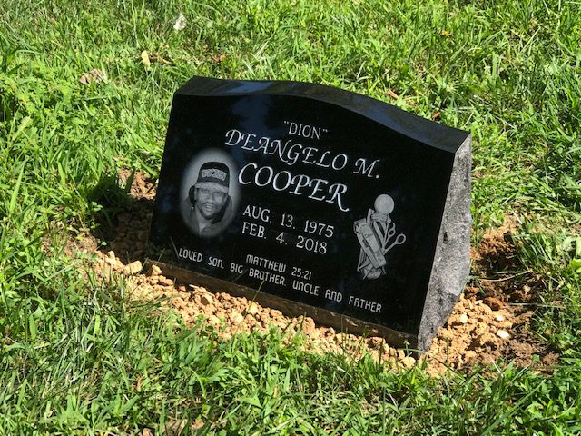 Black granite slant marker with a laser etched portrait and golf bag