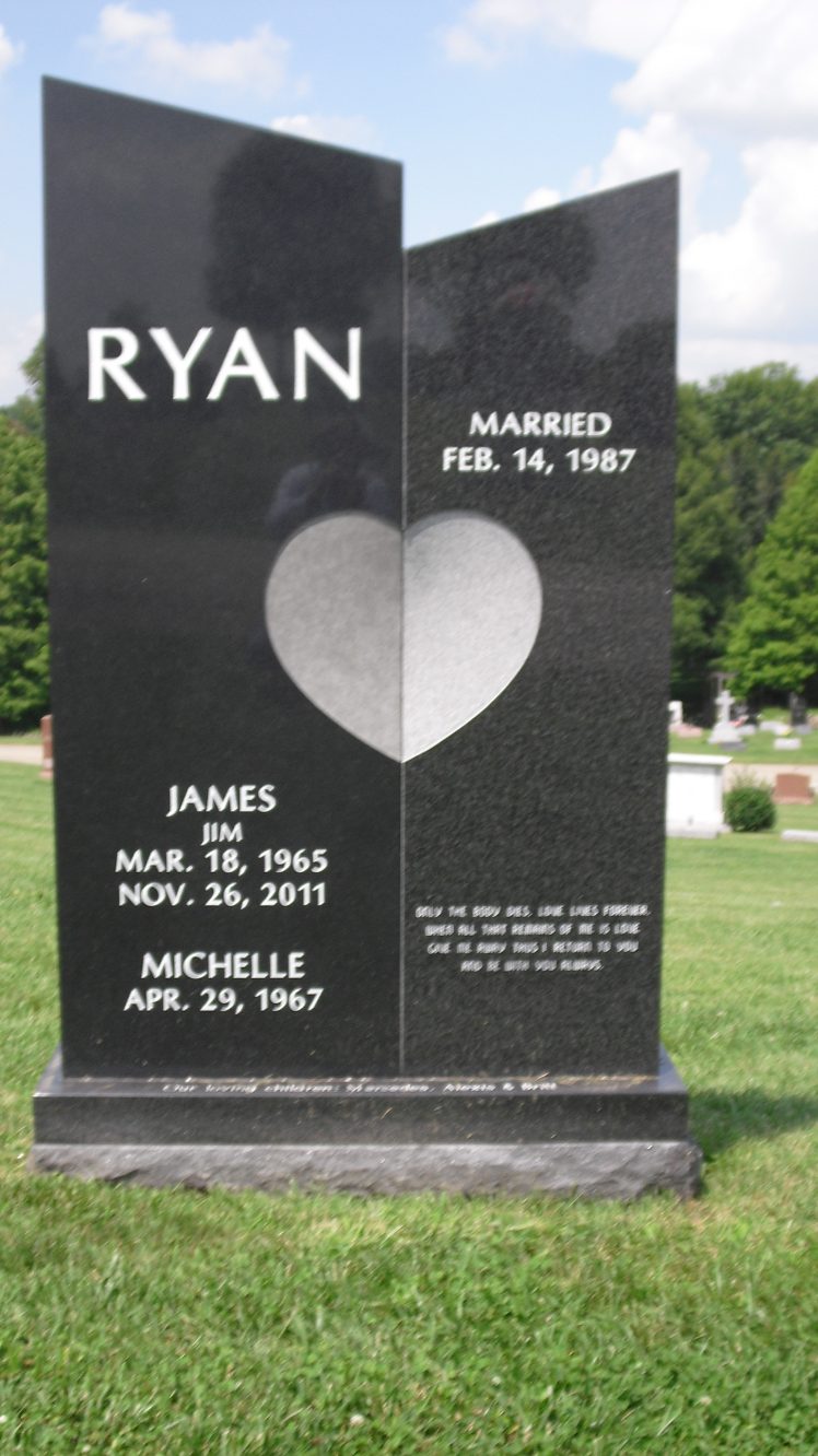 Black granite split upright monument with a polished heart shared across the join